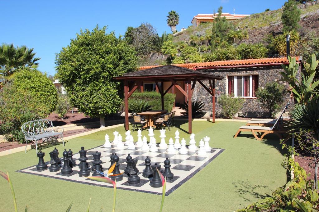 a large chessboard on a lawn in front of a house at Casa Julia Finca Montimar in Guía de Isora