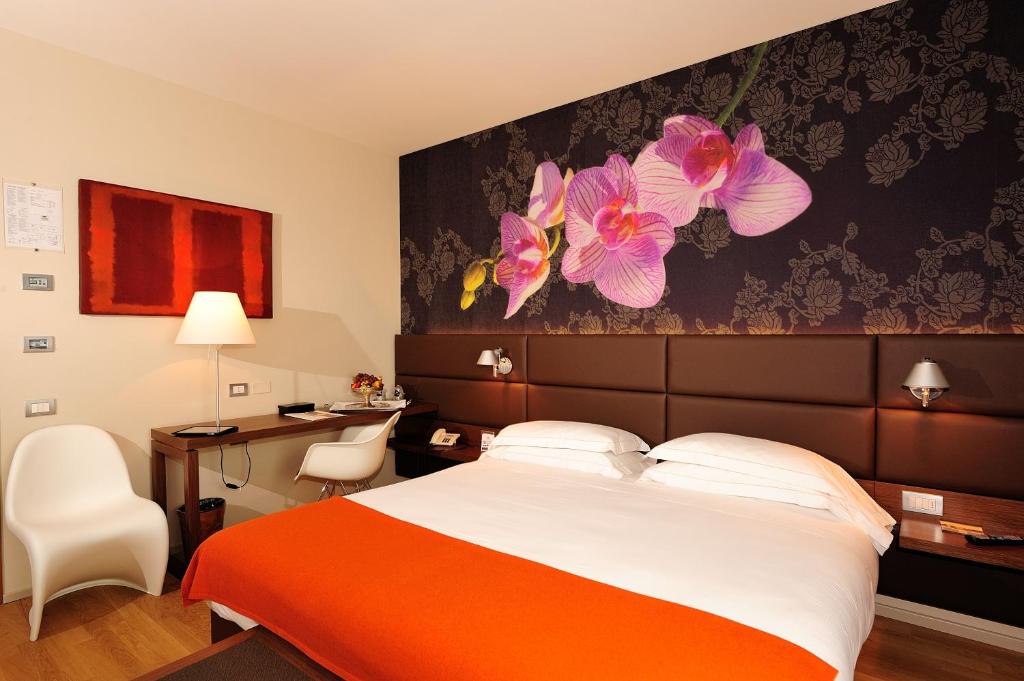 Cama ou camas em um quarto em Dal Moro Gallery Hotel