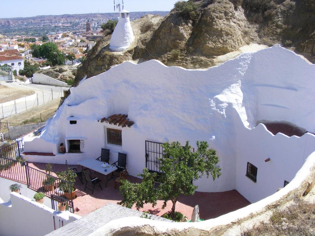 a house with a hole in the side of it at Casa Cueva Guadix in Guadix