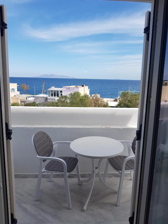 a table and chairs on a balcony with a view of the ocean at Casa Bella in Kamari