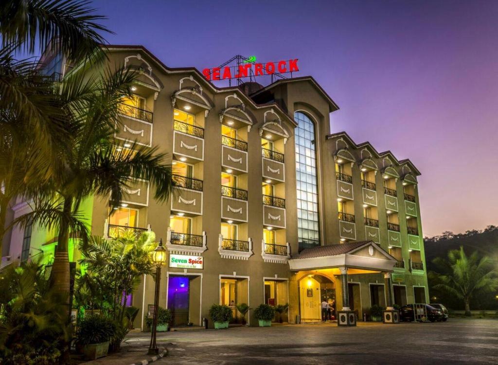 a hotel with a sign on top of it at Hotel Sea N Rock in Thane