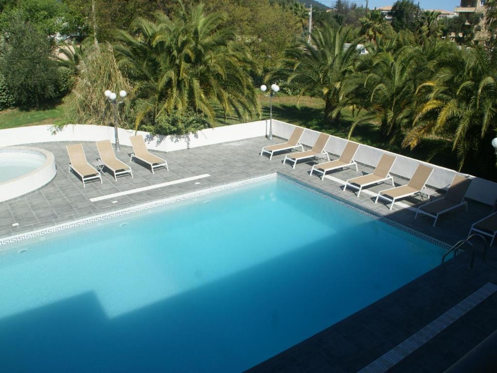 a swimming pool with lounge chairs and a swimming pool at Apartment in Moriani-Plage near the Beach in San-Nicolao