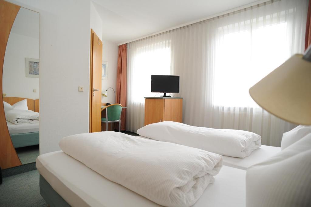 Postel nebo postele na pokoji v ubytování Central-Classic Hotel