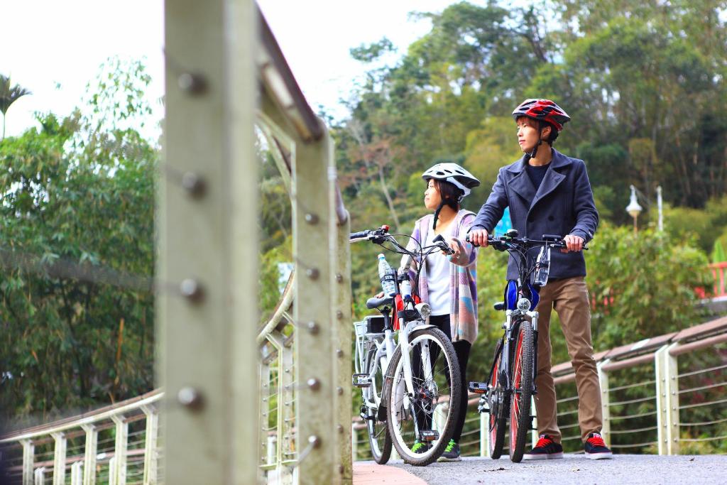 two people with their bikes on a bridge at Fuli Hot Spring Resort in Yuchi