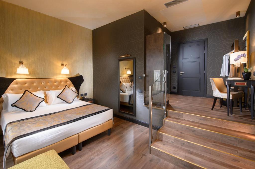 a bedroom with a bed and a desk in a room at Palazzo Veneziano - Venice Collection in Venice