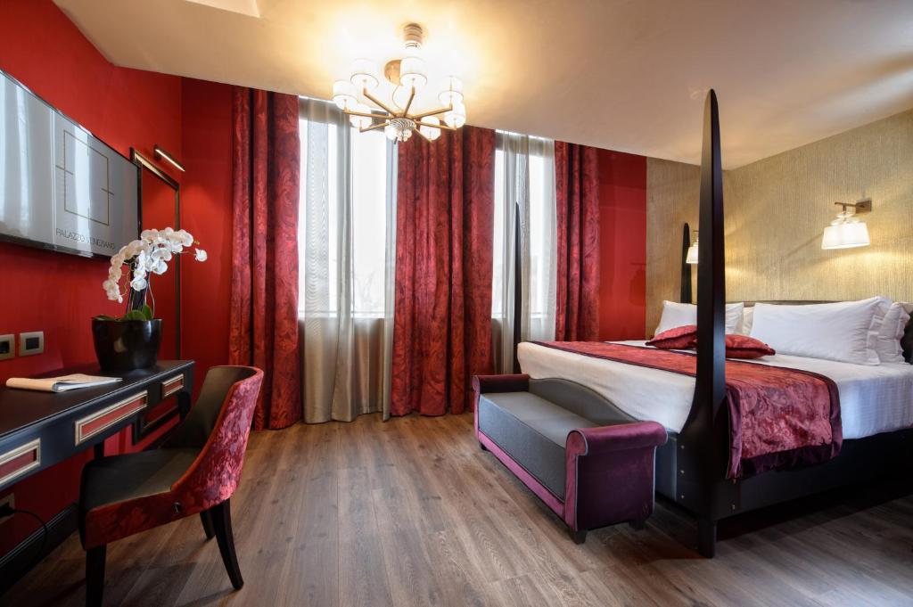 a hotel room with a bed and a desk at Palazzo Veneziano - Venice Collection in Venice