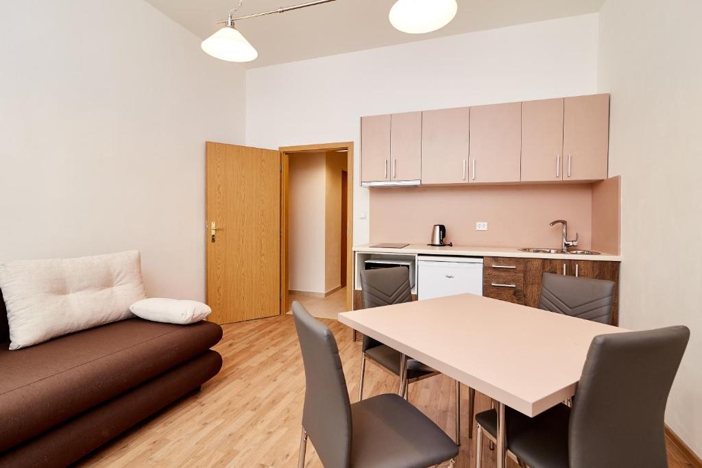 a living room with a couch and a table at Kasablanka apartments in Prague