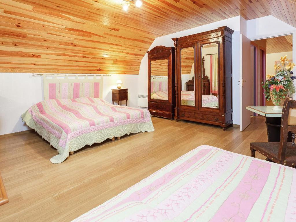 una camera da letto con due letti e soffitto in legno di Calvinet Countryside Escape a Calvinet