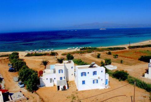 a group of white buildings in front of the ocean at Maistrali Studios & Apartments in Plaka