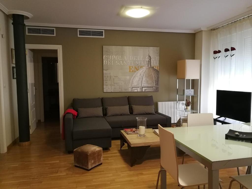 a living room with a couch and a table at 18 Torres El Pilar in Zaragoza
