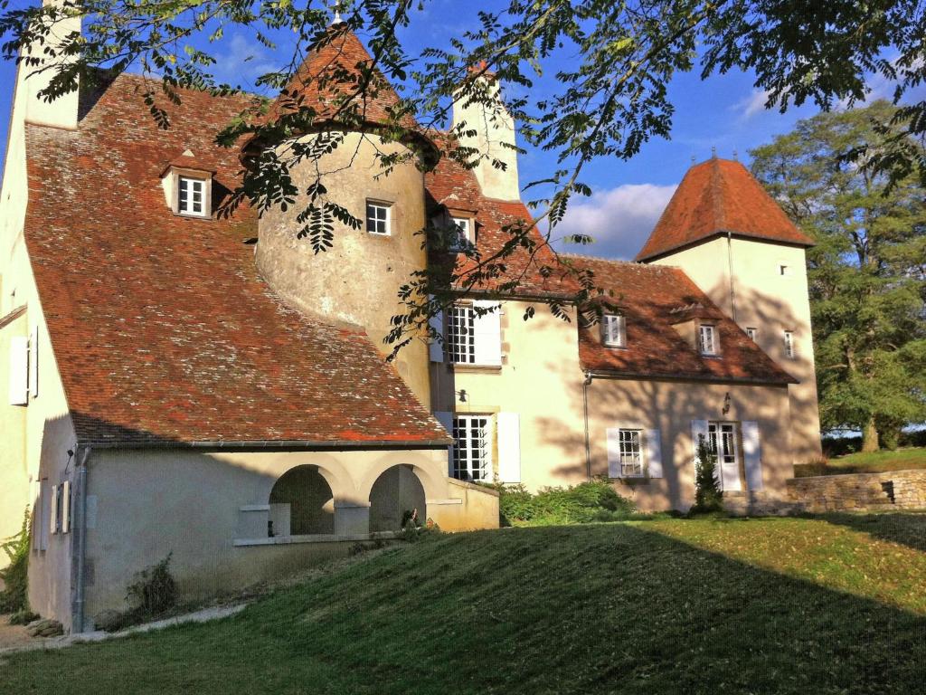 an old house with a red roof on a hill at Ch teau in Auvergne with river and terrace in Le Veurdre