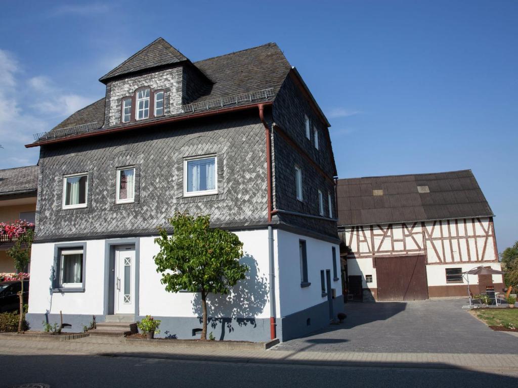 a black and white house with a black roof at Spacious holiday home between Mosel and Hunsr ck in Blankenrath
