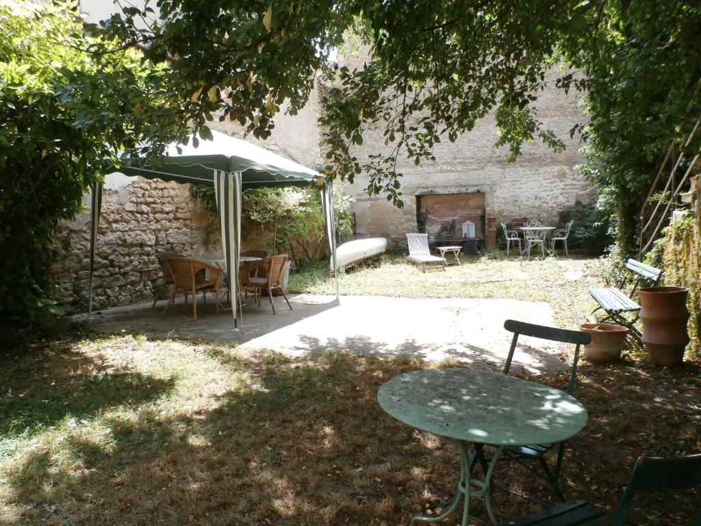 a patio with a table and an umbrella at Rustic holiday home with garden in Gray in Gray