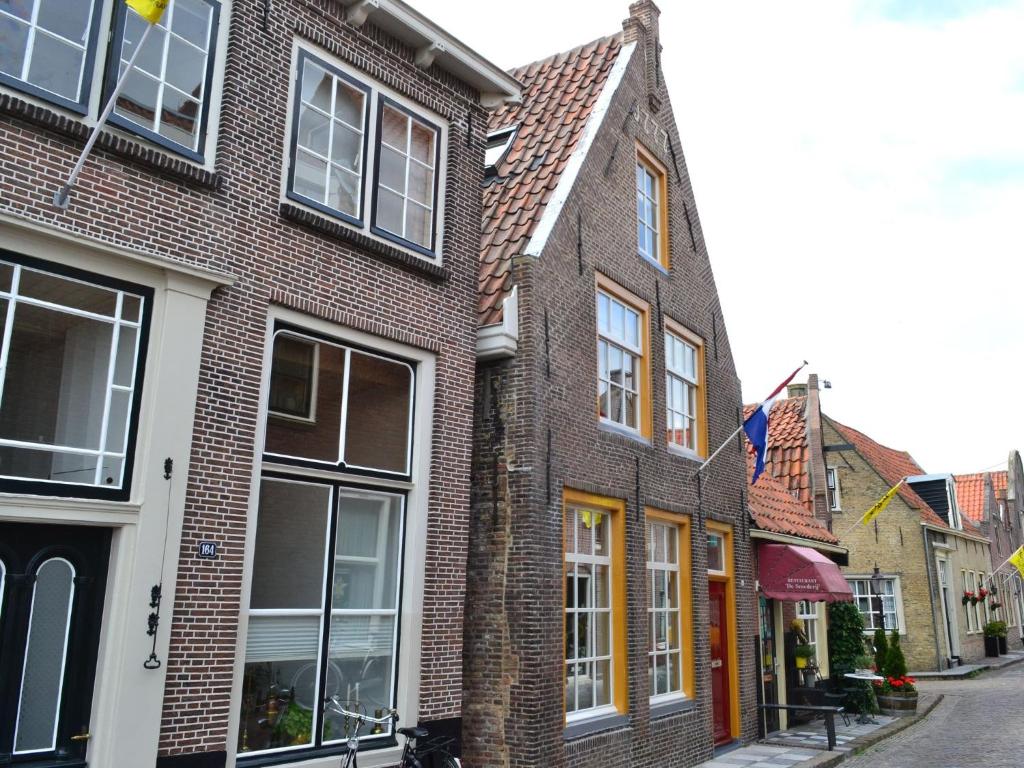 a row of brick houses on a street at Listed 1777 building in historical Enkhuizen in Enkhuizen