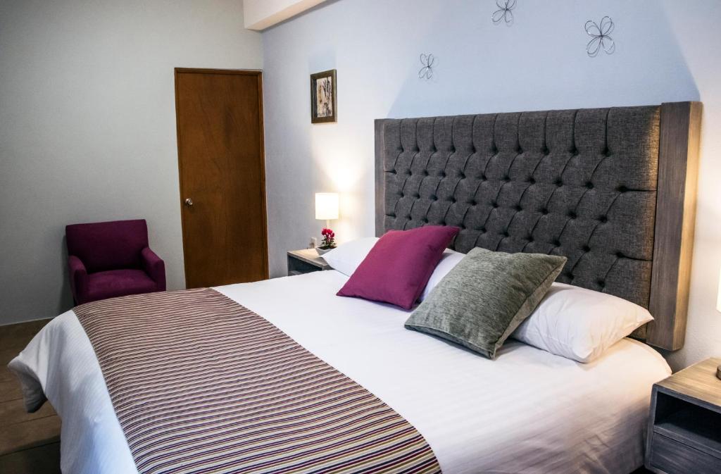 Postel nebo postele na pokoji v ubytování Hotel Casa Aurora
