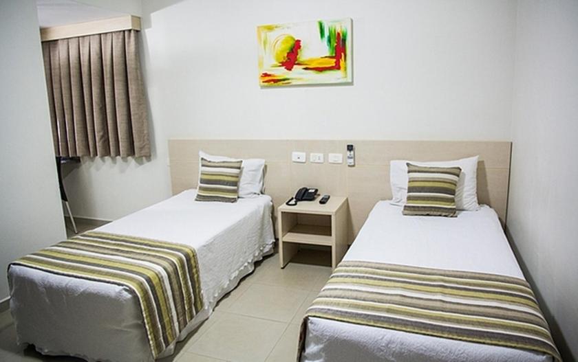 Säng eller sängar i ett rum på Hotel Barrocos