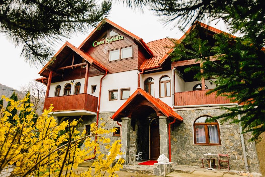 a large house with a wooden roof at Casa Natalia in Sinaia