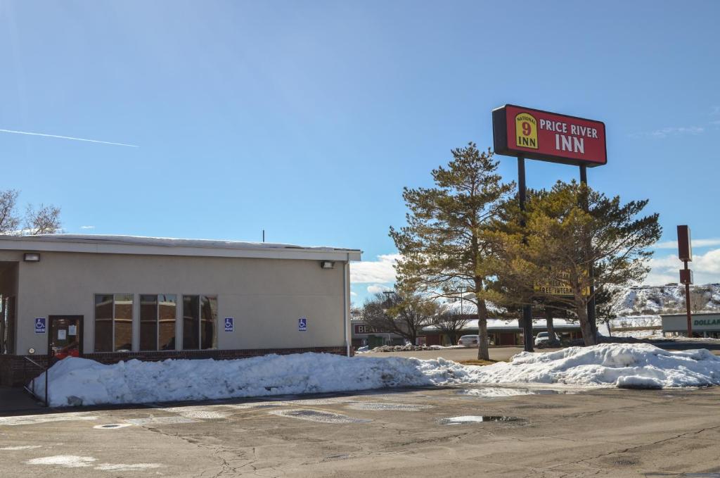 a gas station with a sign in front of it at National 9 Inn Price in Price