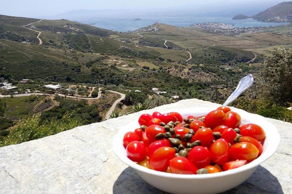 a bowl of tomatoes sitting on top of a table at Anastasia Luxury Villas in Gavrio