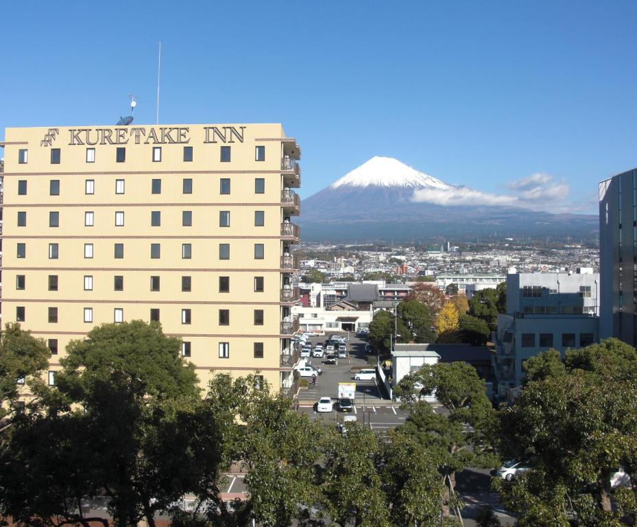 a view of a building with a mountain in the background at Kuretake-Inn Fujisan in Fuji