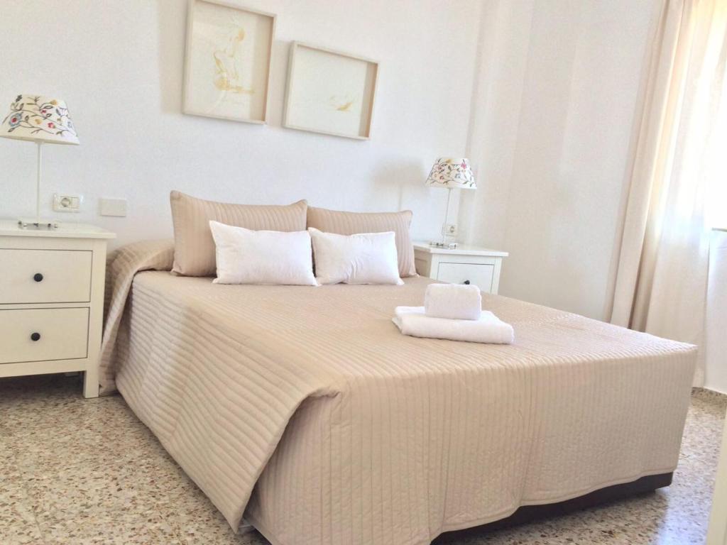 a bedroom with a bed with a towel on it at Hola Apartments 14-3 in Playa de San Juan