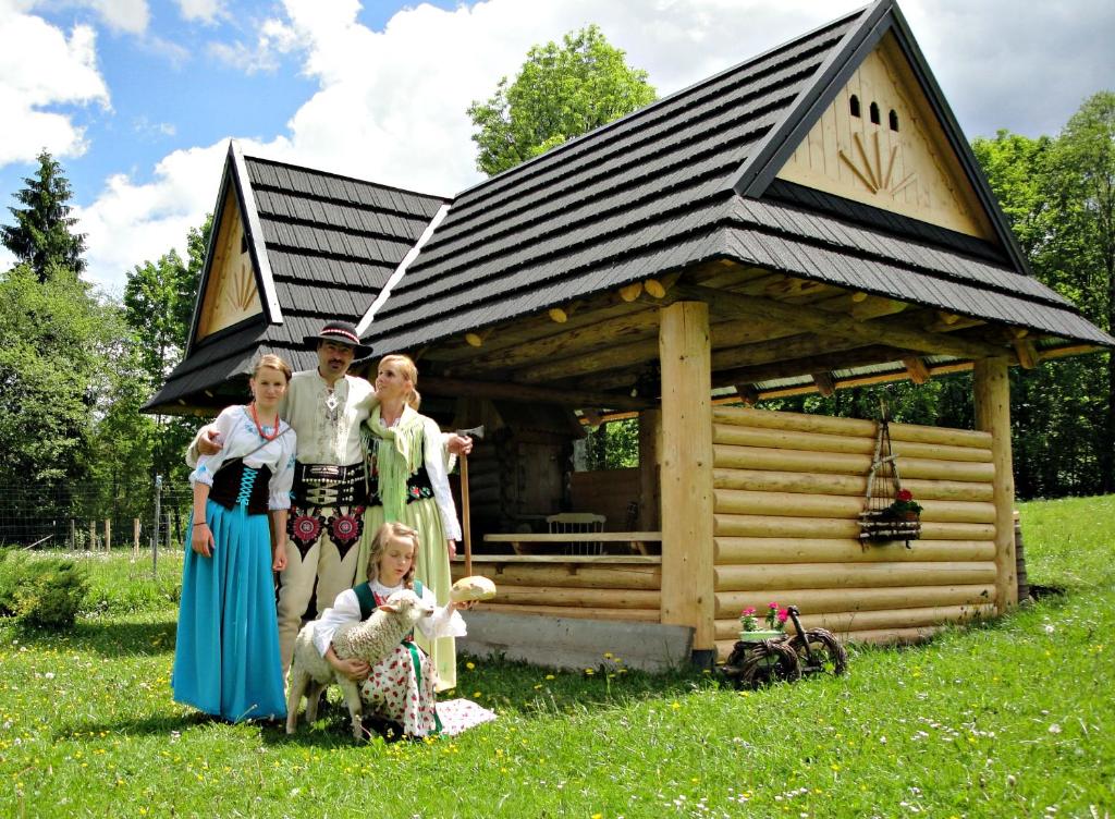 a group of people standing in front of a cabin at Willa Gorska Koleba in Zakopane