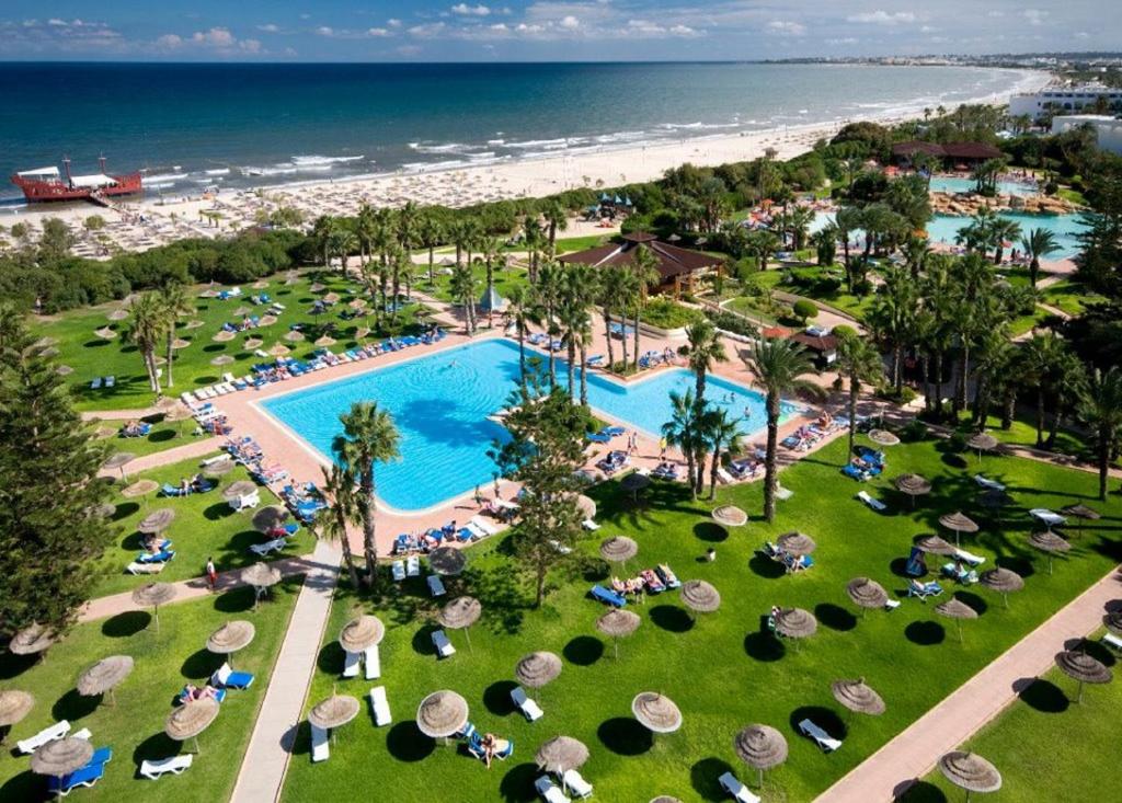 an aerial view of a resort with a swimming pool and the beach at Sahara Beach Aquapark Resort in Monastir