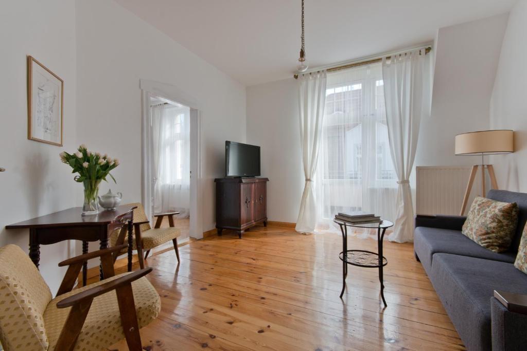 a living room with a couch and a table at Imperial Apartments - Moderna in Sopot