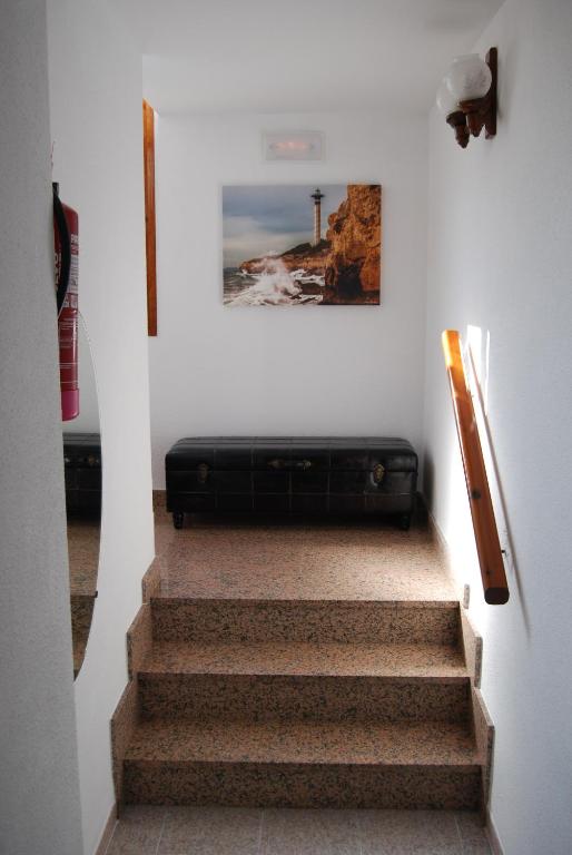 a staircase with a black suitcase on the wall at Hotel Paradís in Torredembarra