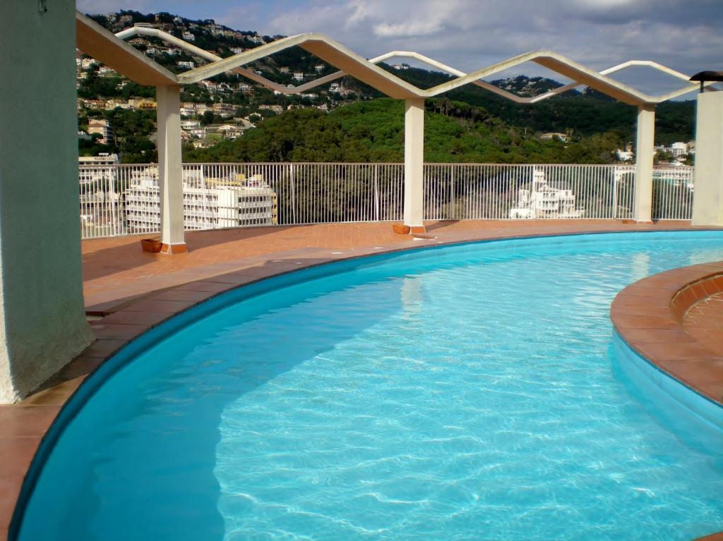 a large swimming pool on a balcony with a view at Acapulco Sol Central Lloret in Lloret de Mar