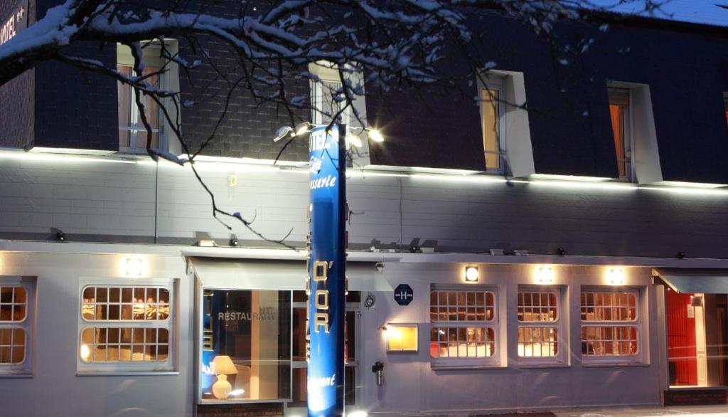 a white building with a blue pole in front of it at L'Etoile d'Or in Chaumont