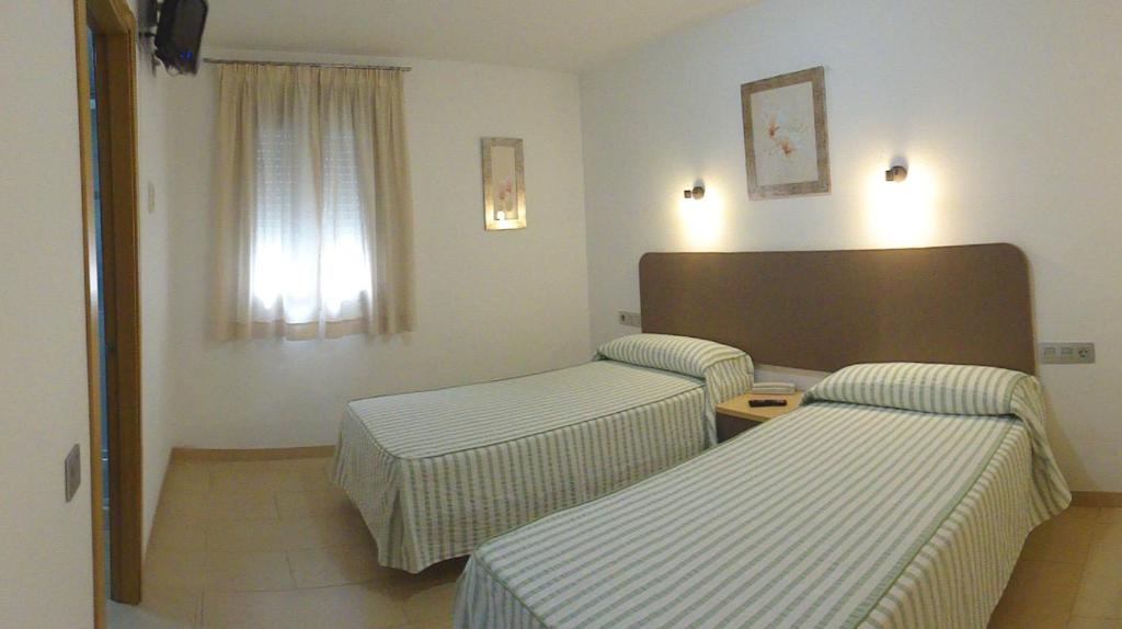 Postel nebo postele na pokoji v ubytování Hostal San Marcos