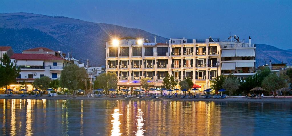 a large building next to a body of water at Trokadero Boutique Hotel in Itea