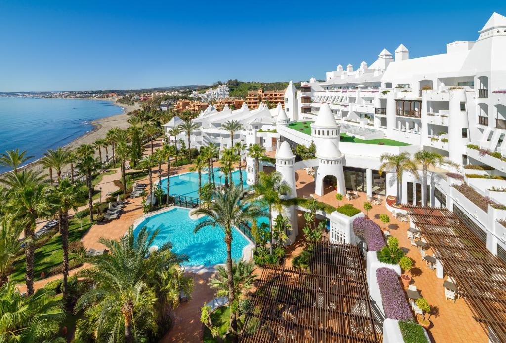 an aerial view of the resort with a pool and the beach at H10 Estepona Palace in Estepona