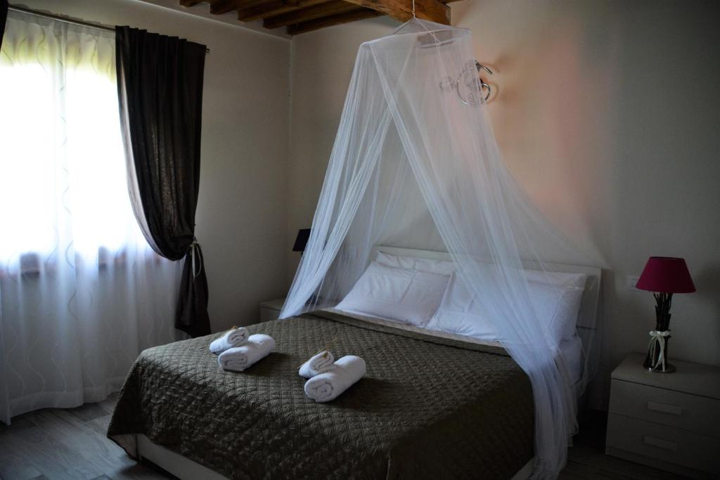 Postel nebo postele na pokoji v ubytování Agriturismo L'Aquilone