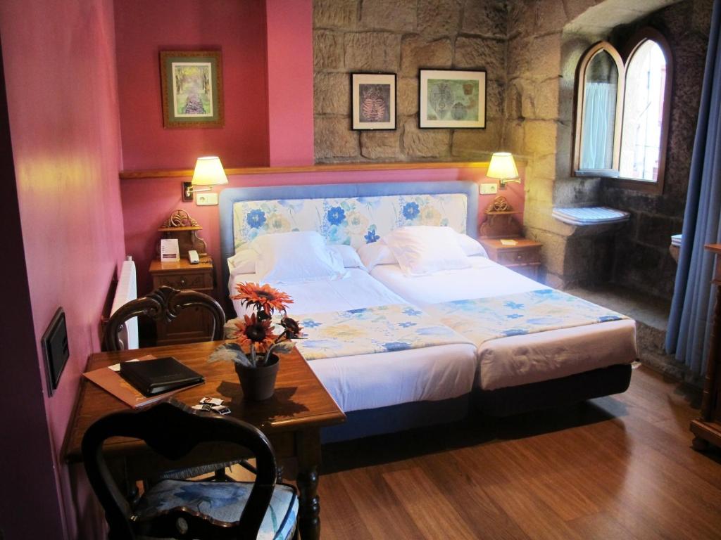 Postel nebo postele na pokoji v ubytování Hotel Palacio Obispo