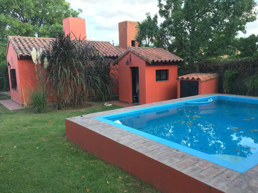 a large swimming pool in front of a house at Pirpintos, Cabanas de San Lorenzo in San Lorenzo