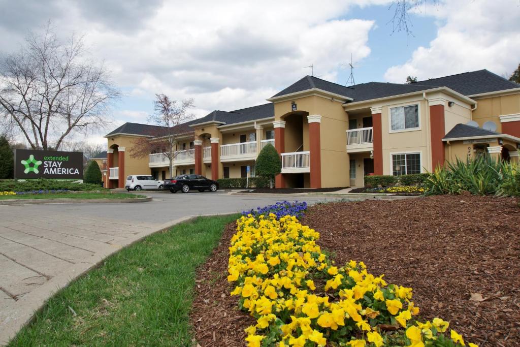 a large house with yellow flowers in a yard at Extended Stay America Suites - Nashville - Airport - Music City in Nashville