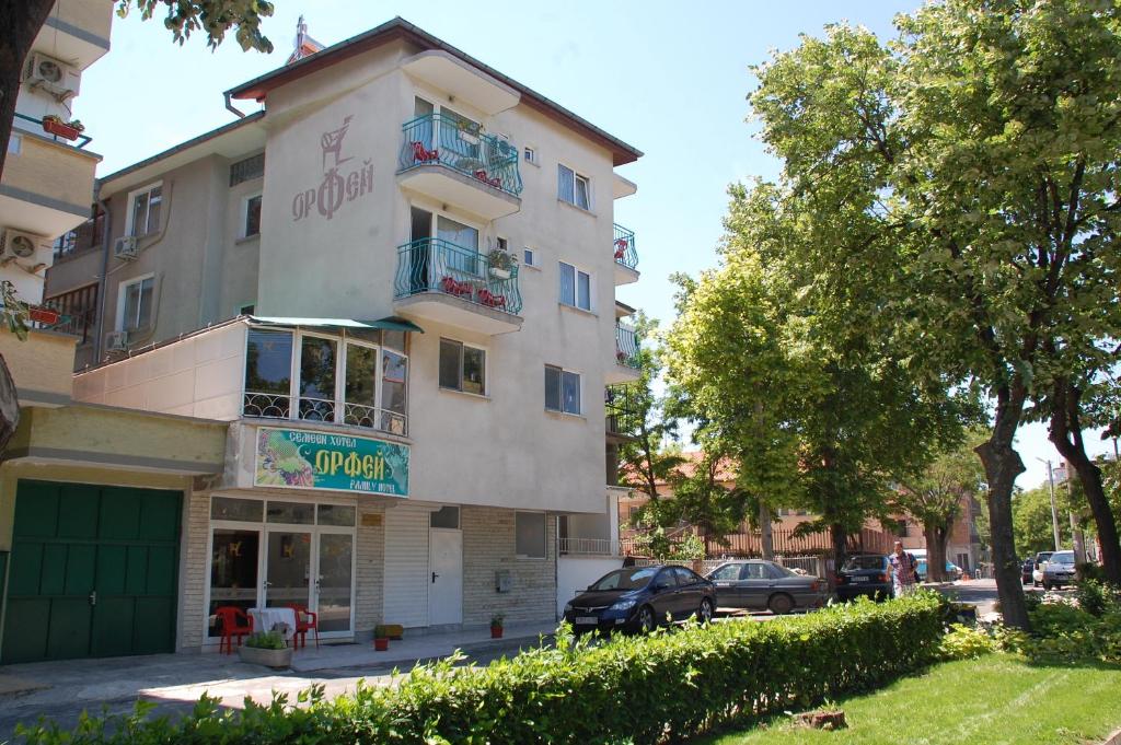 a building with a sign on the side of it at Family Hotel Orfei in Nesebar