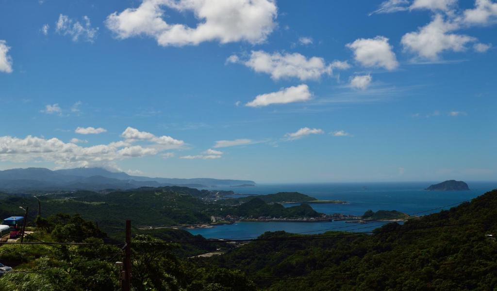 a view of a body of water from a hill at Blue Sky B&amp;B in Jiufen