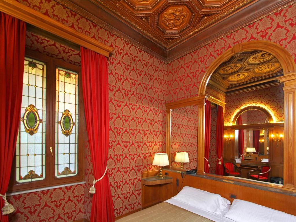 Postel nebo postele na pokoji v ubytování Hotel Arcangelo