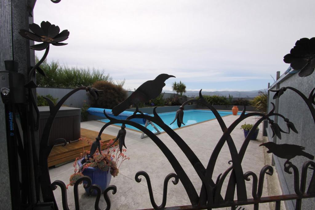 a group of birds perched on top of a fence at Languor B&B in Carterton