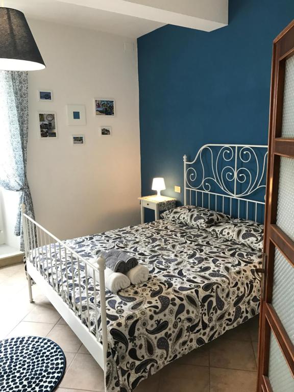 サルテアーノにあるClaves Claustri - Appartamento storico con balconeの青い壁のベッドルーム1室