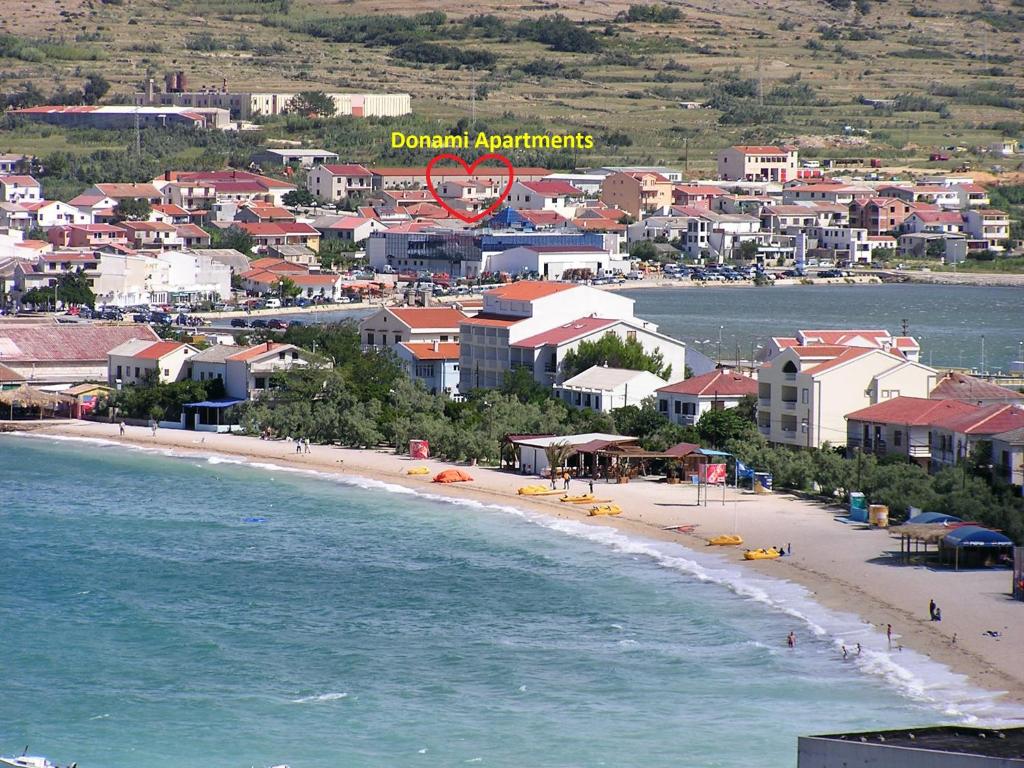an aerial view of a beach with a town at Donami Apartments in Pag