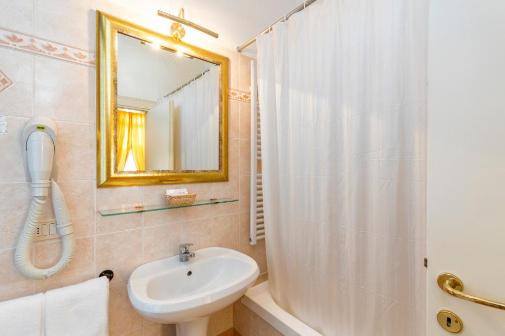 a bathroom with a sink and a shower at Villa Casanova in Venice-Lido