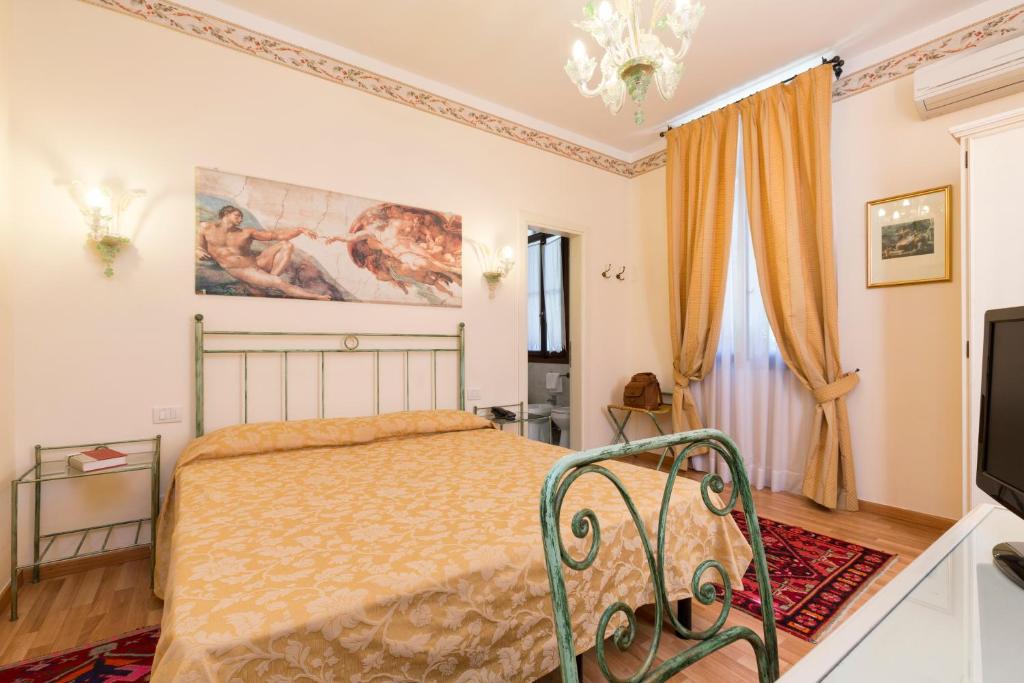 a bedroom with a bed and a television at Villa Casanova in Venice-Lido