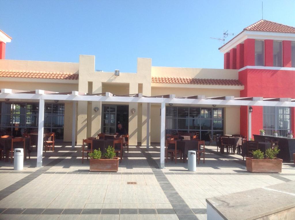 a building with a patio with tables and chairs at Le Torri in Santa Marinella