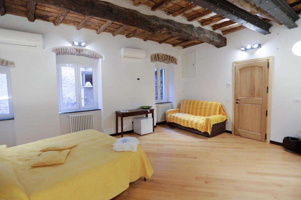 a bedroom with a yellow bed and a chair at Scorci Di Mare in Riomaggiore