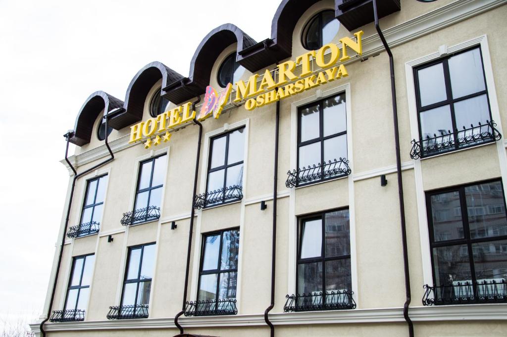 a building with a sign on top of it at Hotel Marton Osharskaya in Nizhny Novgorod