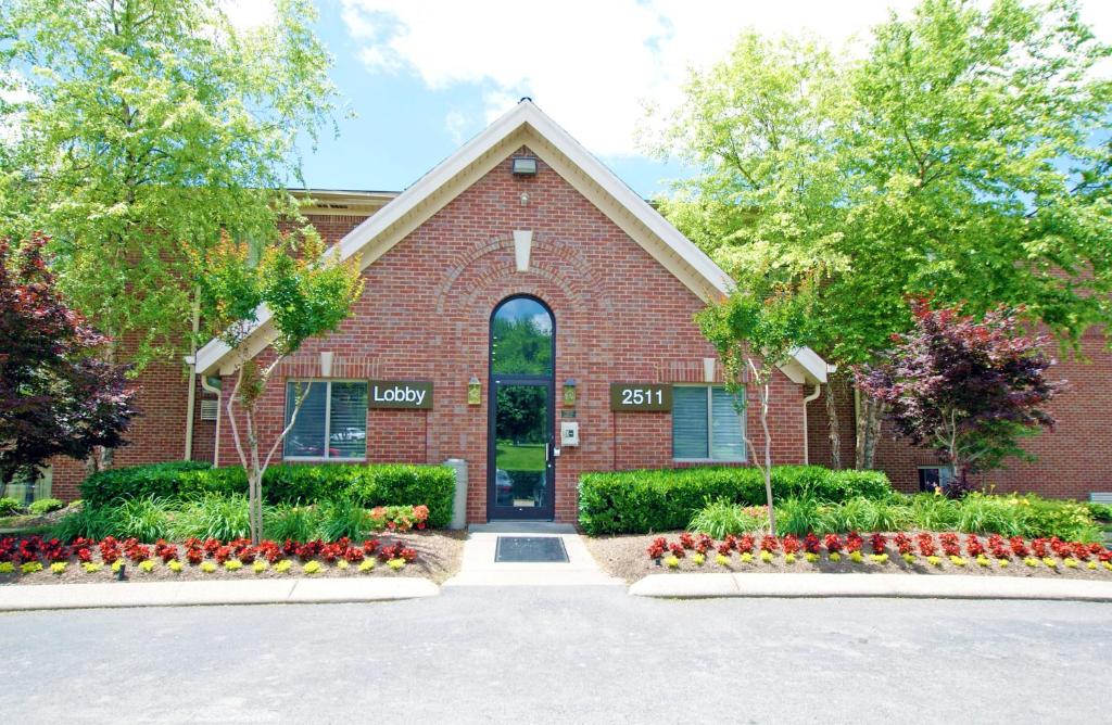 a brick building with flowers in front of it at HomeStay Suites in Nashville